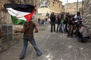 Photographers watching Palestinian stone thrower